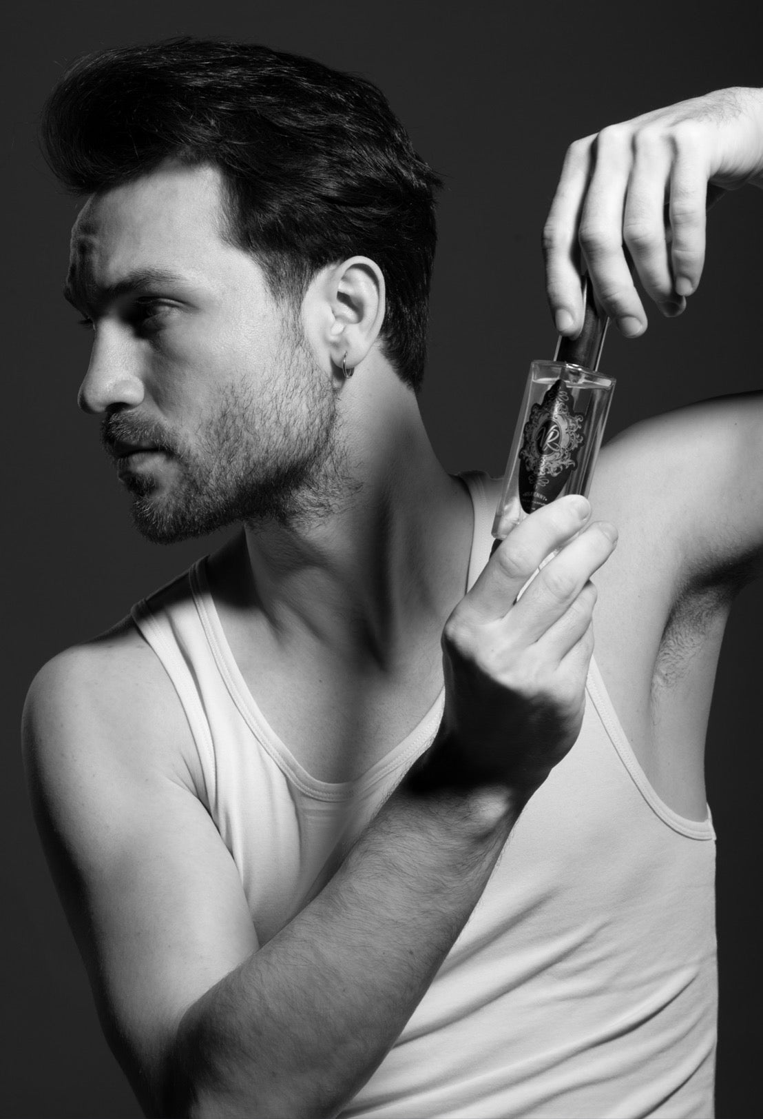 Man holding a Valley of Roses fragrance bottle