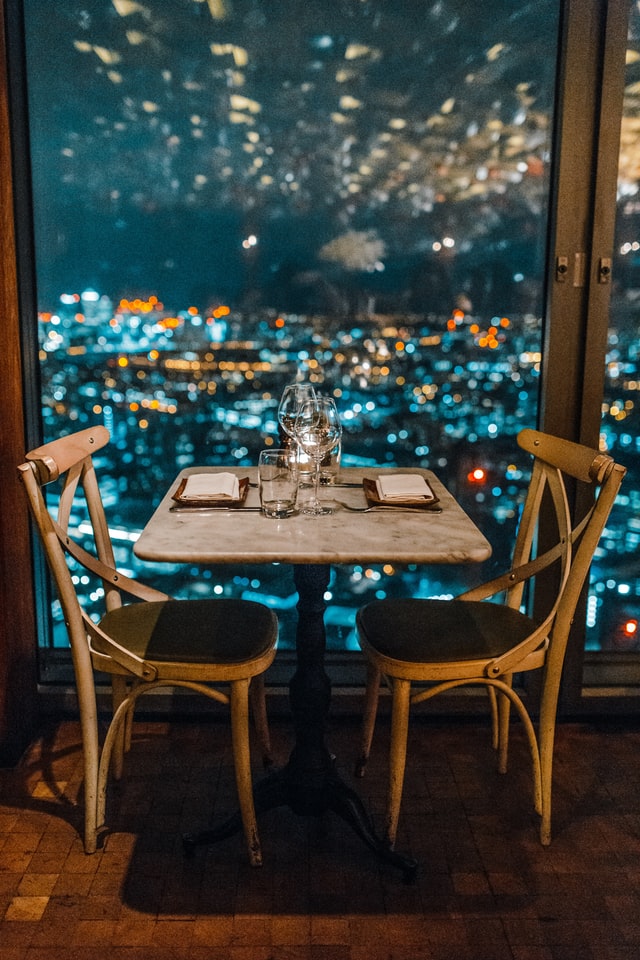 Romantic city view dinner setup; perfect for date night. Explore DATE NIGHT PERFUMES WE SWEAR BY, gift ideas, perfumes Ireland.