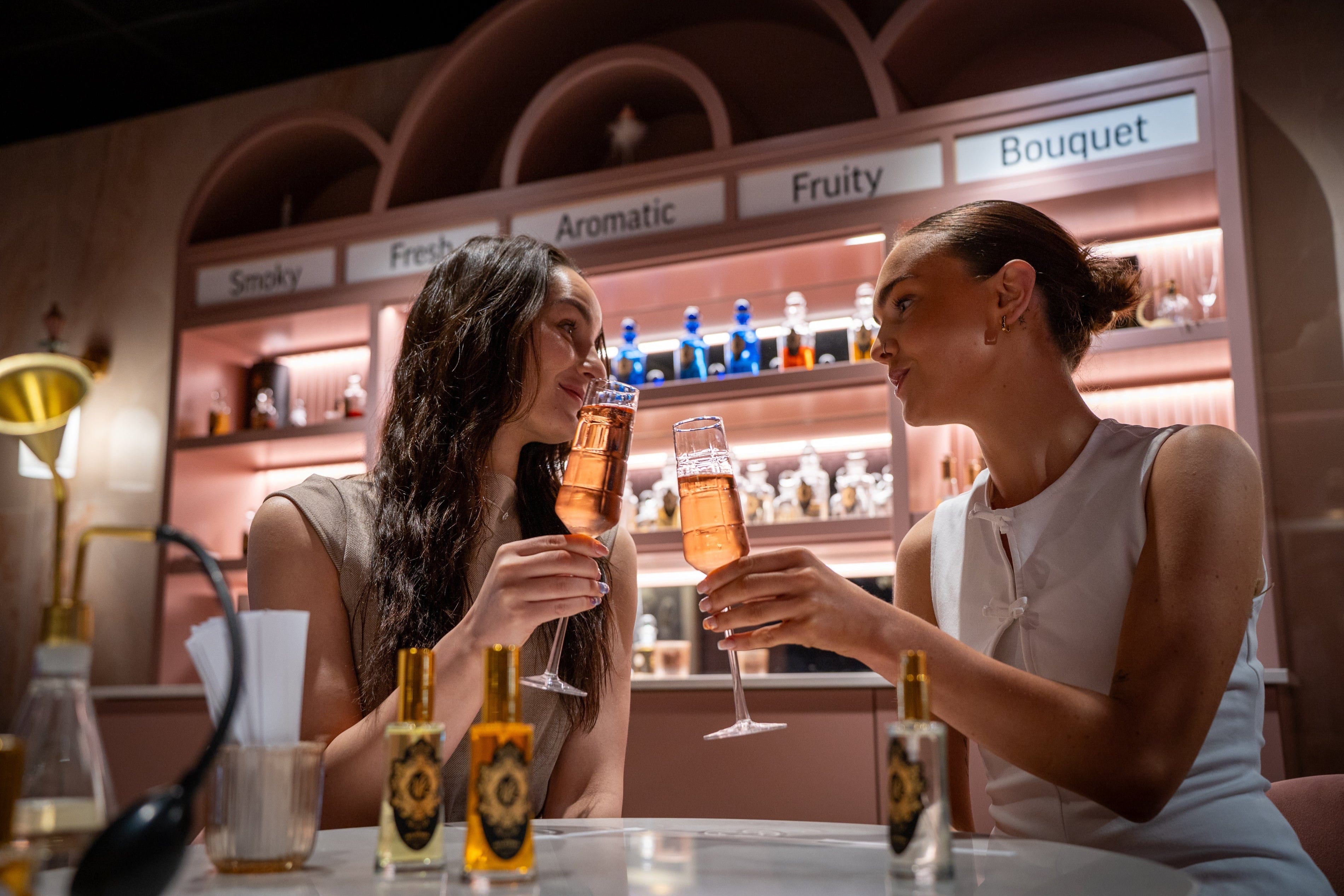Small Group Bespoke Perfume Consultation with two women enjoying drinks and discovering fragrances at Valley of Roses.